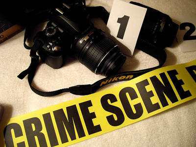 group of items used to document a crime scene including camera and number card