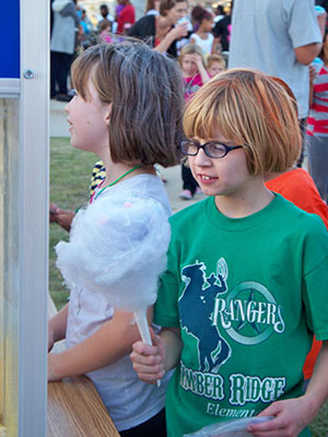 two children eating cotton candy