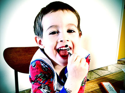 todler in high chair holding a crayon